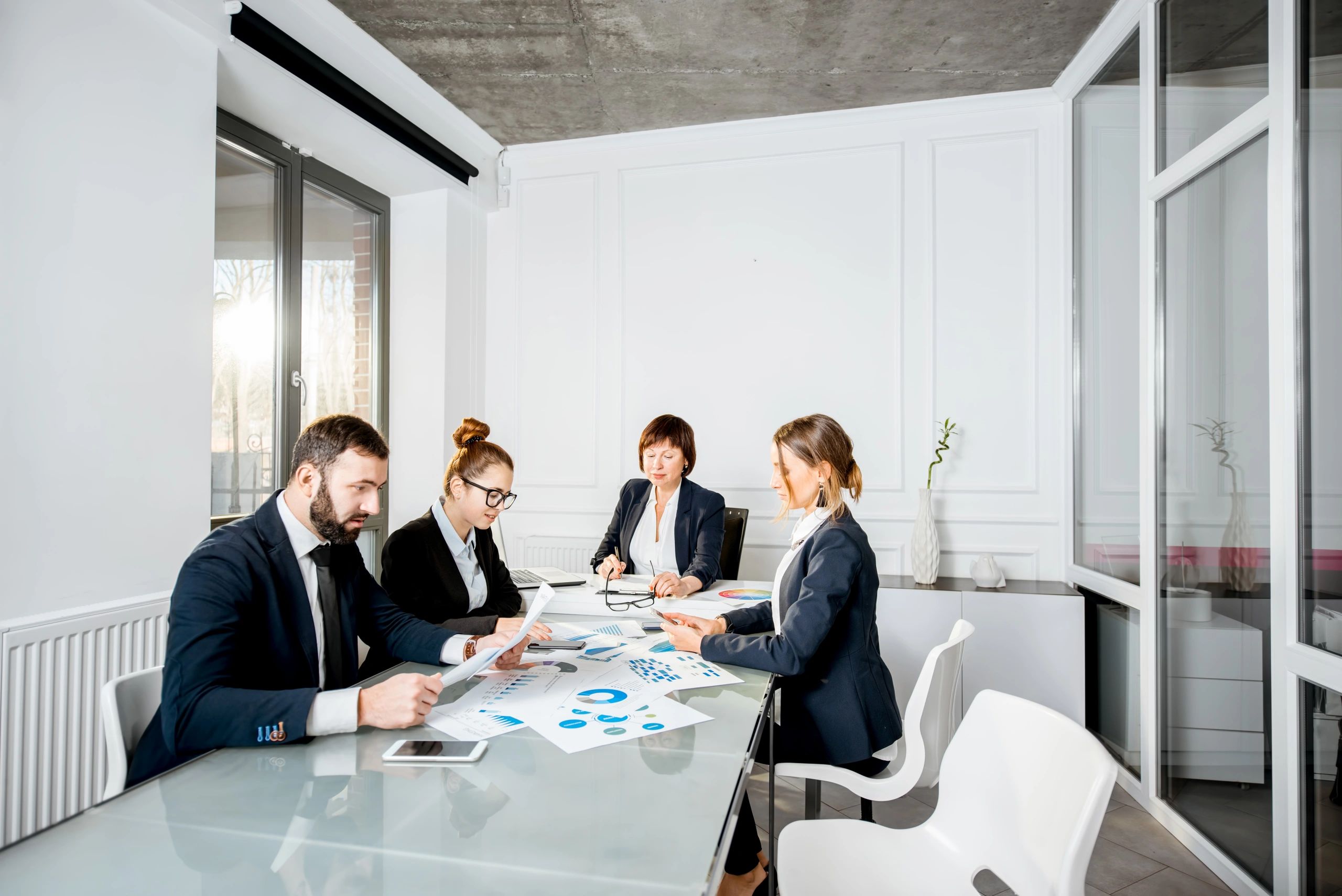Accounting professionals reviewing documents in an office meeting